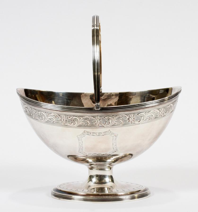 HENRY CHAWNER, LONDON STERLING BONBON BASKET 1790: HENRY CHAWNER, LONDON STERLING BONBON BASKET 1790 H 7" W 6" 6.49 TROY OUNCES Hand chased. Swing handle. Height is with handle raised. No monogram. Weighing 6.49 troy ounces.
