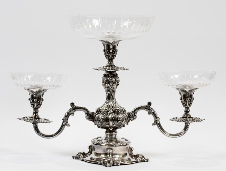 REED & BARTON SILVER PLATE CANDELABRA-EPERGNE: REED & BARTON SILVER PLATE CANDELABRA-EPERGNE H 15.25", W 21", D 9"A Reed & Barton silver plate candelabra. Having fluted glass bobeches, this piece offers three scrolling arms. "Reed & Barton" and "1