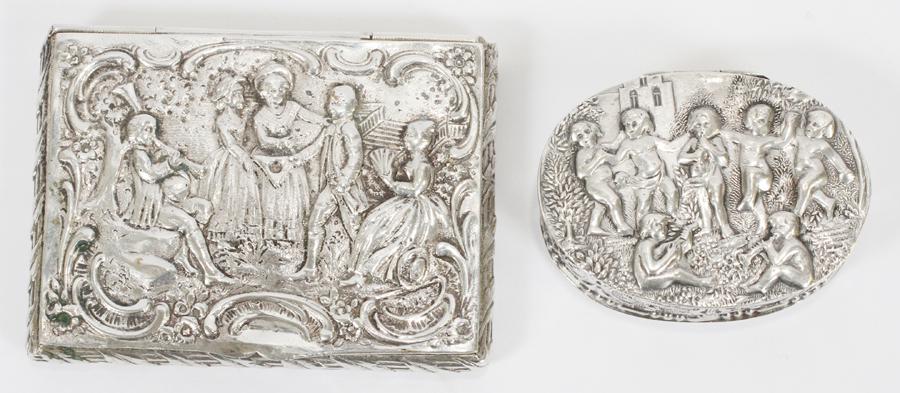 REPOUSSE 800 SILVER HINGED BOXES, 2 PCS: REPOUSSE 800 SILVER HINGED BOXES, 2 PCS, L 2"-3.25", 3.56 OZT A selection of two 800 silver hinged boxes. Each having a repousse design of social scenes and cherubs. Each having "800" and illegible si