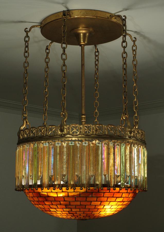 TIFFANY STUDIOS BRONZE & LEADED GLASS CHANDELIER: TIFFANY STUDIOS BRONZE & LEADED GLASS MOORISH STYLE CHANDELIER, H 42". DIA 26" Numbered and signed, "A552 Tiffany Studios New York" on the interior of the leaded shade. Bronze ceiling plate suspending