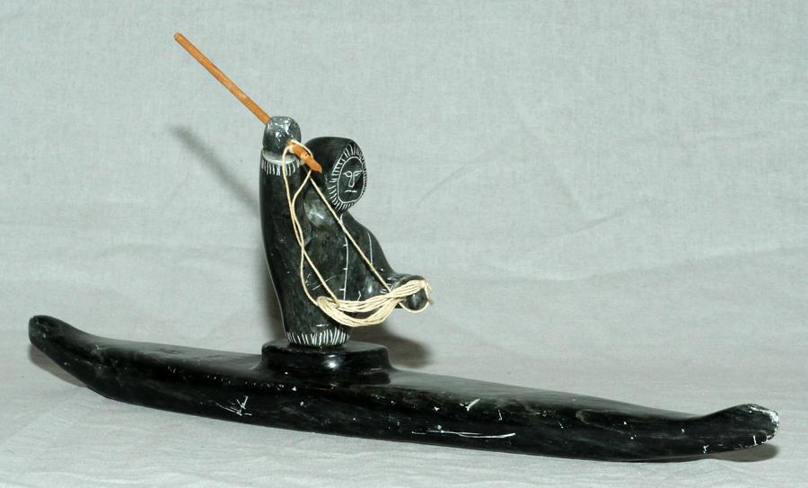 CANADIAN, INUIT SCULPTURE H 5" L 14": CANADIAN, INUIT SCULPTURE H 5" L 14" Canadian Inuit sculpture of a fisherman in a kayak, unsigned. The sculptuer measures height 5" and length 14".
