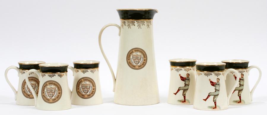 F. EARL CHRISTY HARVARD BASEBALL PITCHER & MUGS: F. EARL CHRISTY HARVARD BASEBALL POTTERY PITCHER & MUGS C. 1906 H 11" A set of Harvard baseball pottery mugs with a matching pitcher. Depicting a Harvard baseball player in a gray uniform with crimson