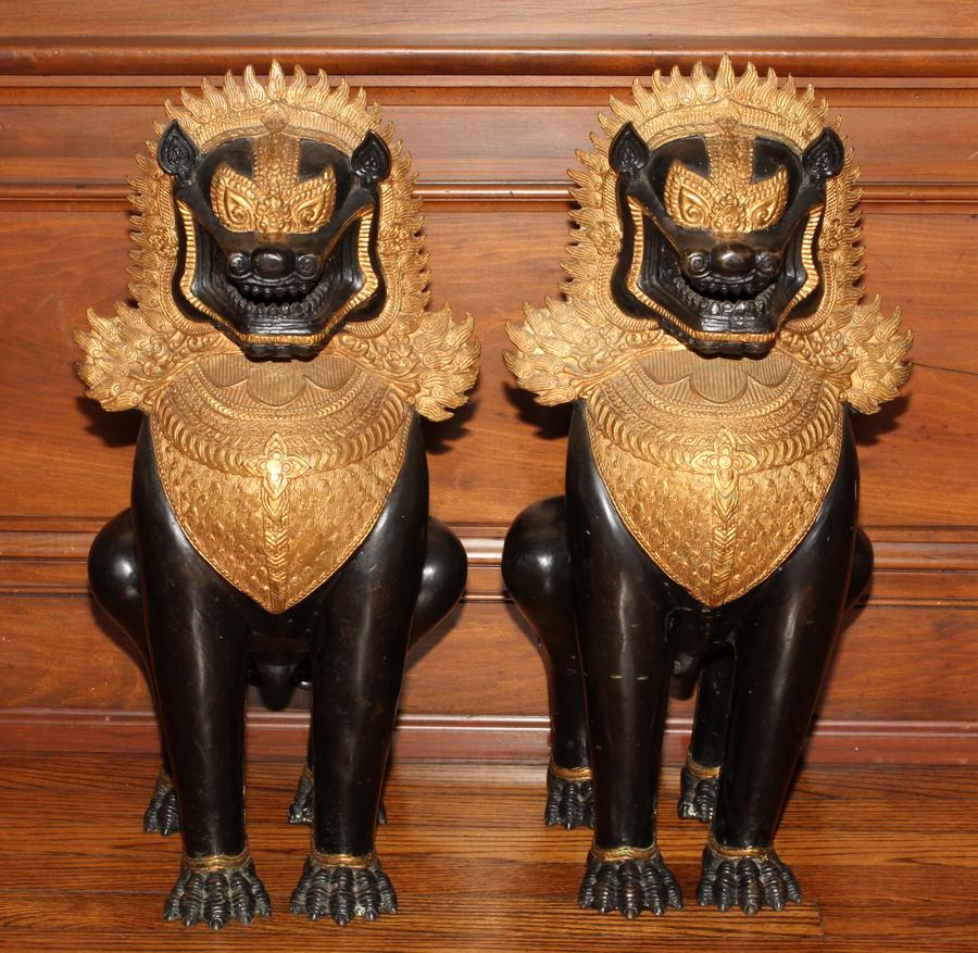 CHINESE METAL FOO LION GUARDIANS, PAIR: CHINESE METAL FOO LION GUARDIANS, PAIR, H 25", W 12" Black with gilt shields on breasts, gilt flame halo surrounding head.