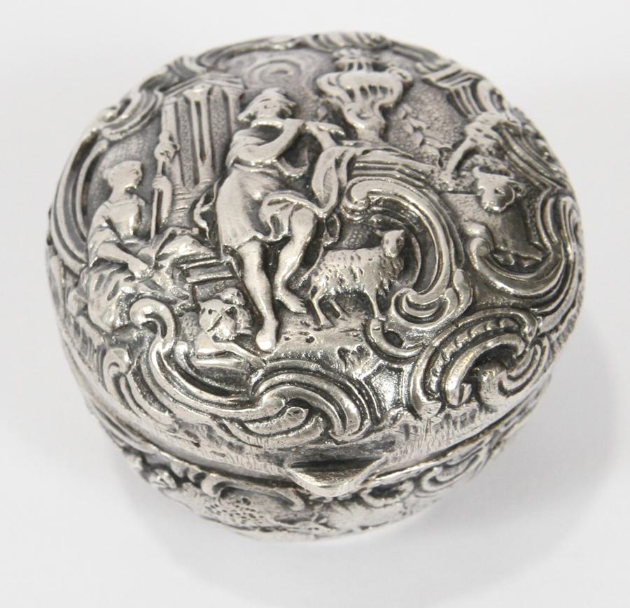 DUTCH SILVER ROUND REPOUSSE PILL BOX: DUTCH SILVER ROUND REPOUSSE PILL BOX, 19TH. C DIA 2" OZT. 1.25 Scene in relief on cover. Hinged lid. Weighing 1.25 troy ounces.