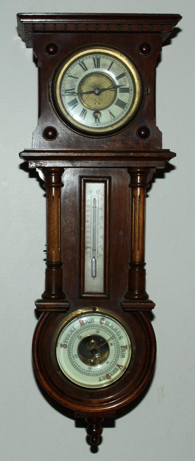 HAMBERG - AMERICA, CLOCK CO., WALNUT, WALL CLOCK: HAMBERG - AMERICA, CLOCK CO., WALNUT, WALL CLOCK/BAROMETER/ THERMOMETER, C. 1920, H 23", W 8" Hamberg - America, Clock co., walnut, wall clock/barometer/ thermometer, C. 1920, H 23", W 8" . With key a