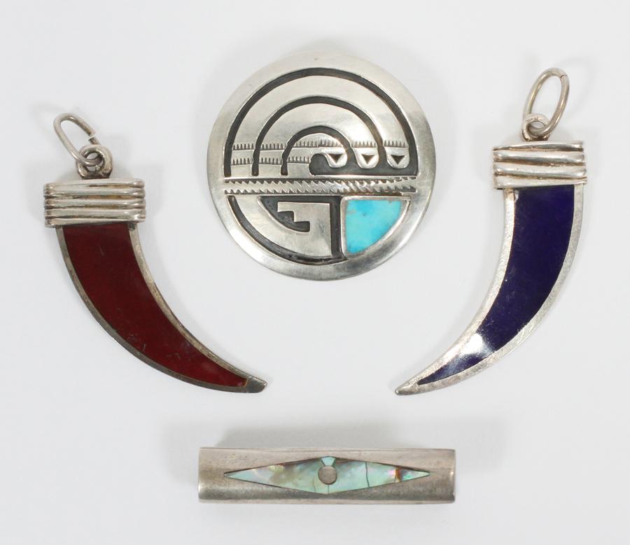 STERLING PENDANTS, 4 PIECES: STERLING PENDANTS, 4 PIECES Includes: one pair of sterling silver "Tiger Claw" pendants, blue and dark orange enamel, total weight of pair 19.7 grams. One silver Zuni Native American design round disk