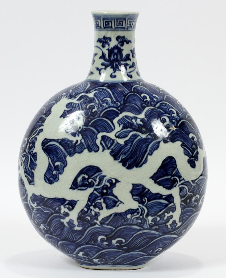 CHINESE BLUE & WHITE PORCELAIN VASE, H 12", W 9": CHINESE BLUE & WHITE PORCELAIN VASE, H 12", W 9"A Chinese blue and white porcelain vase. Having an ellipsoid bodice with etched dragon motif juxtaposed with blue underglaze forms.