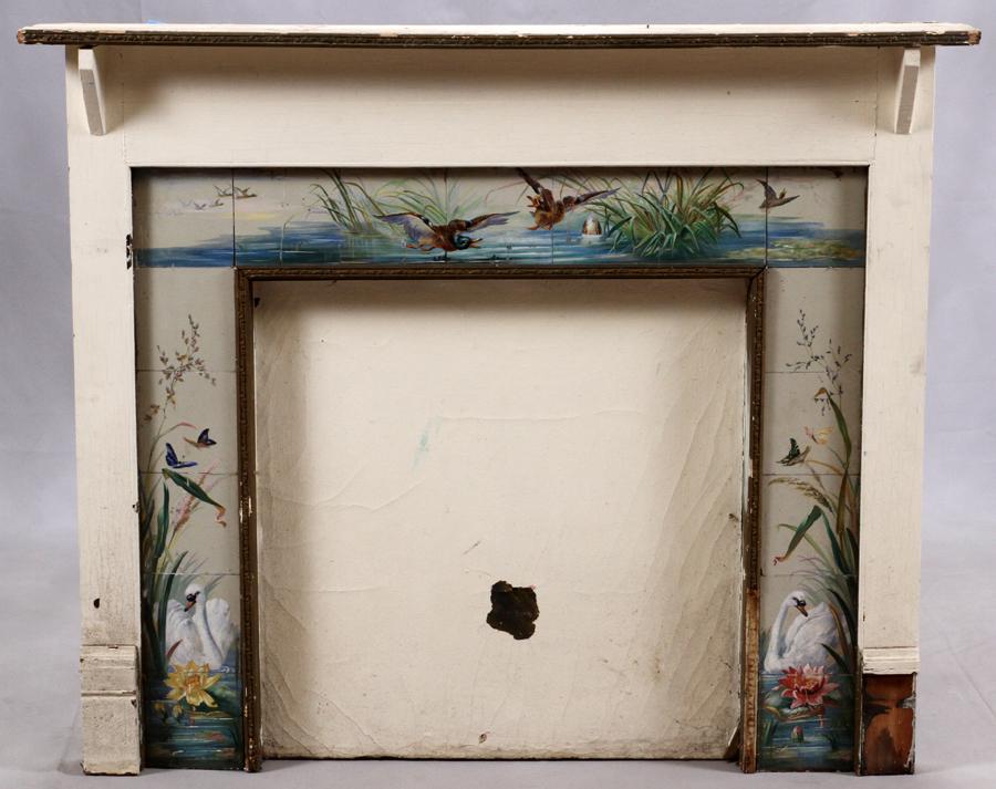 WOOD, TILE FIREPLACE MANTEL & TILE SURROUND: OLD CLUB HARSENS ISLAND HAND PAINTED, WOOD, TILE FIREPLACE MANTEL & TILE SURROUND H 44" W 52" D 7" A wooden fireplace mantel with a hand-painted tile surround. Tiles depict ducks and waterways. This f