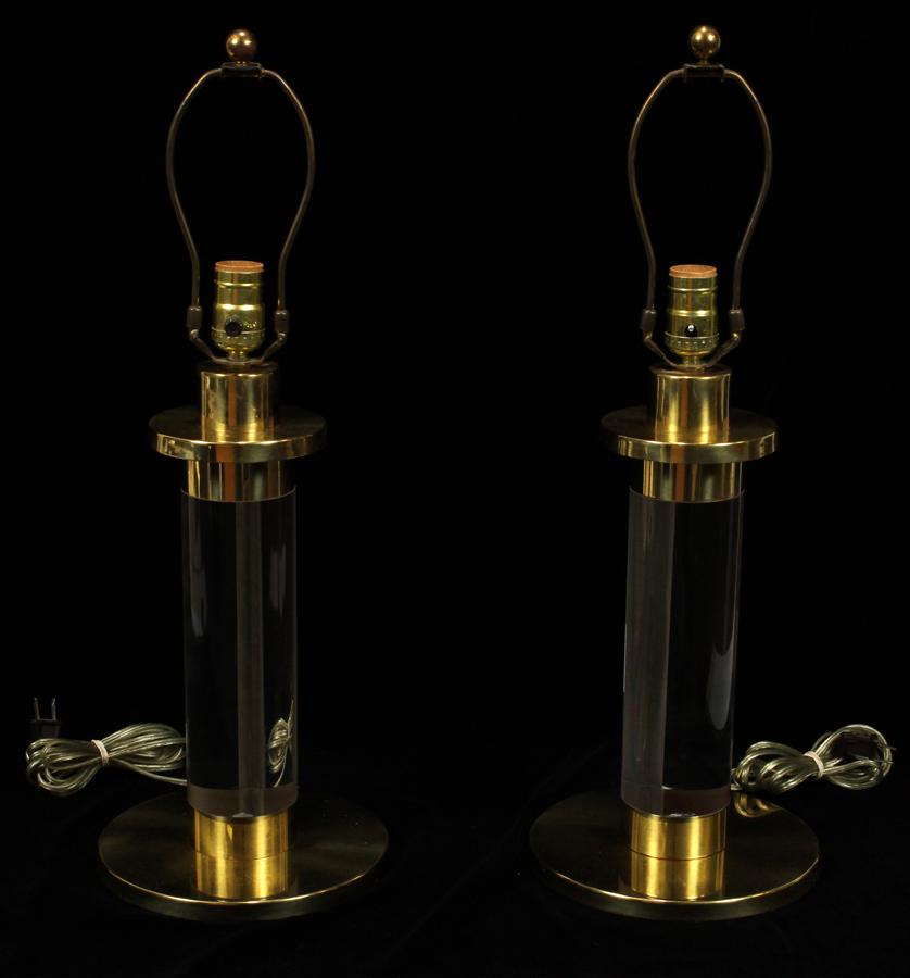 PAIR MODERNIST LUCITE & BRASS LAMPS: PAIR MODERNIST LUCITE & BRASS LAMPS H 22.5" DIA 8.5" Each having a lucite pillar with brass bases. In the manner of Carl Springer.