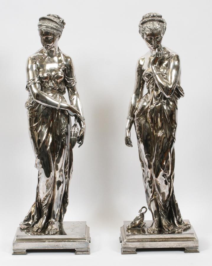SILVER PLATE ALLEGORICAL FIGURES, PAIR: SILVER PLATE ALLEGORICAL FIGURES, PAIR H 29.5", W 9.5", D 6" A pair of female allegorical figures, one with an oil lamp at her feet and the other holding an amphora.