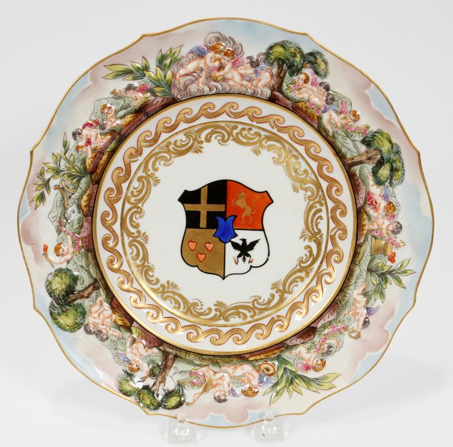 CAPODIMONTE ARMORIAL CABINET PLATES, 18 PCS: CAPODIMONTE ARMORIAL CABINET PLATES, 18 PCS, DIA 10.5" Shield crest, raised figural border. Hand painted. Gilt highlights