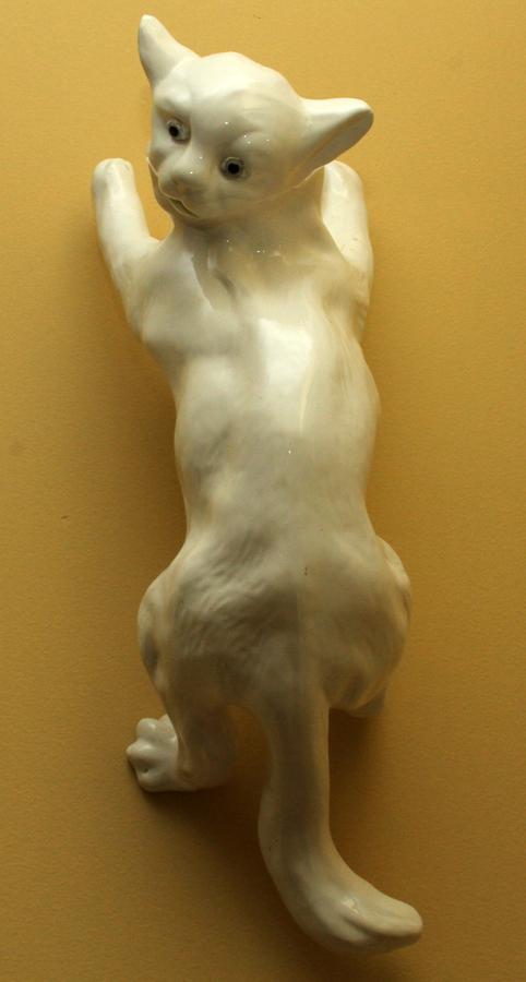 FRENCH CERAMIC CAT WALL ORNAMENT: FRENCH CERAMIC CAT WALL ORNAMENT, W 8", L 21" A ceramic wall hanging ornament. Depicting a tabby cat having a cream tone glaze. Reminiscent of the cat statues of York, England. Impressed "France"