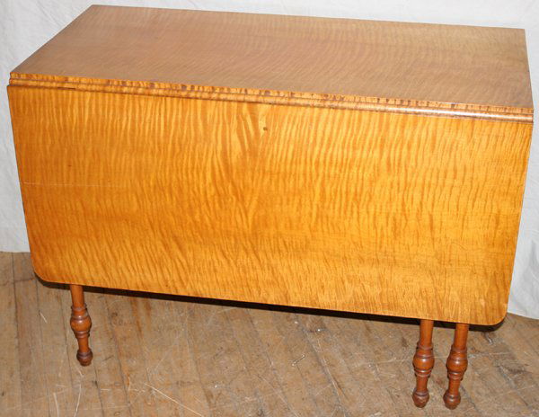 AMERICAN TIGER STRIPE MAPLE DROP-LEAF TABLE: AMERICAN TIGER STRIPE MAPLE DROP-LEAF TABLE, 19TH CENTURY, H 29", W 18 1/2", L 40":Rectangular top flanked by drop leaves, each 18" wide, a single drawer at one end, raised on turned supports. From th