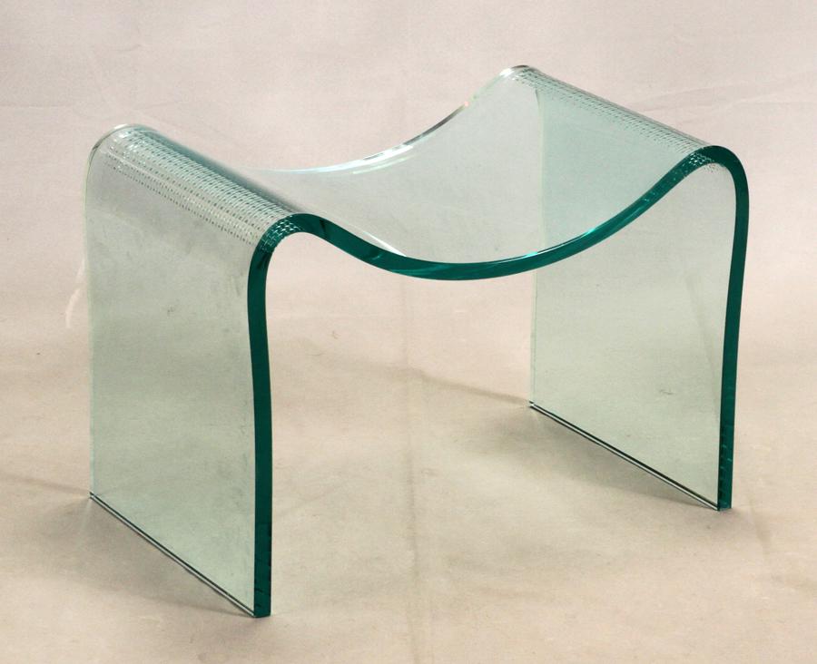 LAUREL FYFE MODERNIST GLASS BENCH, H 16", W 23", D 14": LAUREL FYFE (AMERICAN, 1956-2011) MODERNIST GLASS BENCH, H 16", W 23", D 14" A modernist glass bench formed of a single piece of bent glass.