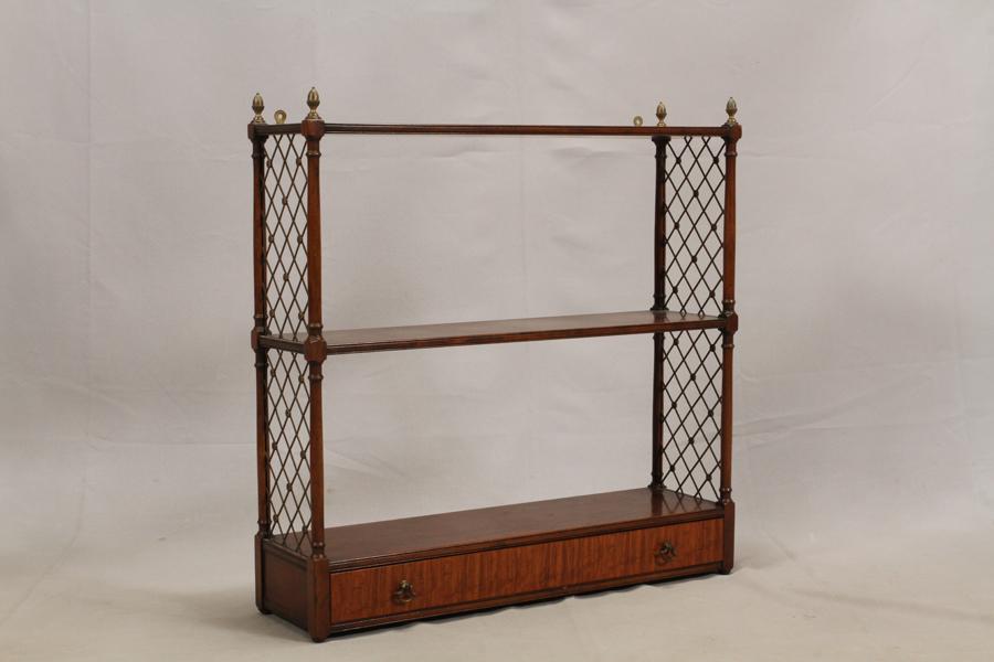 KITTINGER WALL MOUNT CURIO SHELVES, H 26", W 26": KITTINGER WALL MOUNT CURIO SHELVES, H 26", W 26" 3 shelves, one drawer, and brass grill side panel. Property of Robert Schweizer, Ann Arbor.