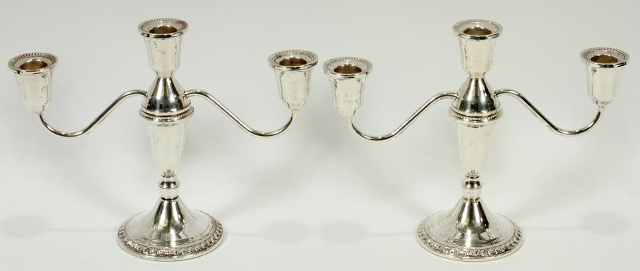 DUCHIN WEIGHTED STERLING CANDELABRAS, PAIR: DUCHIN WEIGHTED STERLING CANDELABRAS, PAIR, H 7.5", W 10"A pair of Duchin weighted sterling silver candelabras. Each having three candle cups with branding impressed to the underside.