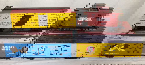 BACHMANN "BIG HAULERS" "G" SCALE FREIGHT CARS &: Includes (1) Missourie, Kansas & Texas stock car #98117, (1) Arm & Hammer bill board box car, #93254, (1)"Hershey Kisses" bill board reefer, #93252 & (1) Rio Grande Southern, 4 wheel bobber caboose, #