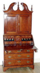 AMERICAN CHERRY SECRETARY DESK, CONNECTICUT, CI: Scroll pediment, slant-front desk opening to envelope slots and small drawers, two document drawers, above four graduated drawers, raised on bracket feet. Invoice from Thomas and Constance Williams