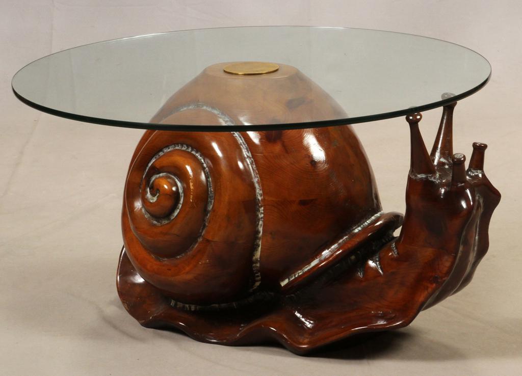 FEDERICO ARMIJO SNAIL FORM WOOD & GLASS TABLE: FEDERICO ARMIJO SNAIL FORM WOOD & GLASS TABLE H 17" DIA 32" Having a carved wooden base in the form of a snail with a round glass top.