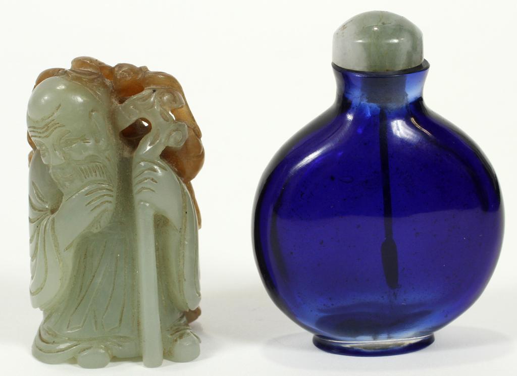 CARVED JADE WISE MAN & A COBALT GLASS SNUFF BOTTLE: CARVED JADE WISE MAN & A COBALT BLUE GLASS SNUFF BOTTLE, 2 PCS. H 2"& 2.25" The carved jade wise man is holding a staff and standing in front of a pomegranate tree with a deer in front of the tree, th