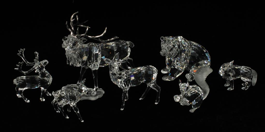 SWAROVSKI CRYSTAL ANIMAL FIGURINES, 8 PCS: SWAROVSKI CRYSTAL ANIMAL FIGURINES, 8 PCS, H 2.5"-5"A collection of Swarovski crystal North American animal figurines. Comprised of a fox, squirrel, bear, deer, caribou and moose. WIth boxes.