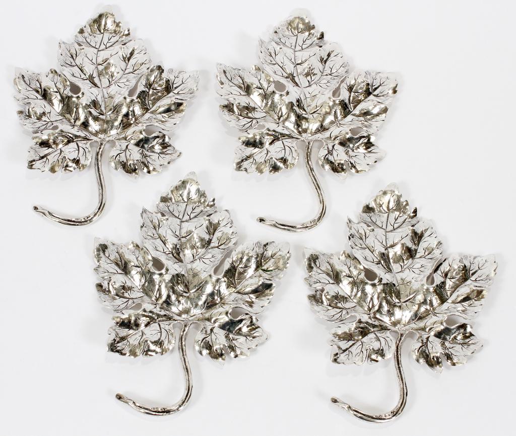 MAPLE LEAF SILVER TABLE ORNAMENTS, 4 PCS, L 7": MAPLE LEAF SILVER TABLE ORNAMENTS, 4 PCS, L 7"A four-piece collection of silver table ornaments. Each having a maple leaf form. Silver hallmarks impressed to stem includes a star, wheat and profile sy