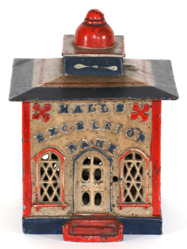 'HALLS EXCELSIOR BANK' MECHANICAL BANK, 1860: 'HALLS EXCELSIOR BANK' MECHANICAL BANK, 1860, H 6", W 4", D 4"A mid-19th century iron mechanical bank. Designed by John Hall, patented December 21, 1869, and manufactured by Cromwell, Connecticut J. &