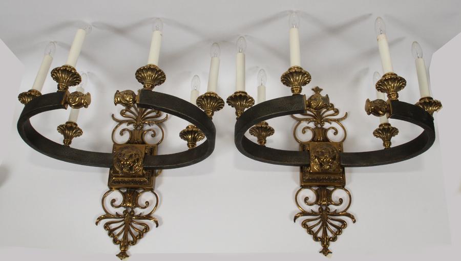 MAITLAND SMITH HAMMERED METAL & BRASS SCONCES: MAITLAND SMITH, LION MASK, HAMMERED METAL & BRASS SCONCES, PAIR H 22", W 23" A pair of Maitland Smith sconces made of hammered metal with polished brass accents. Having lion masks and scrolling motifs