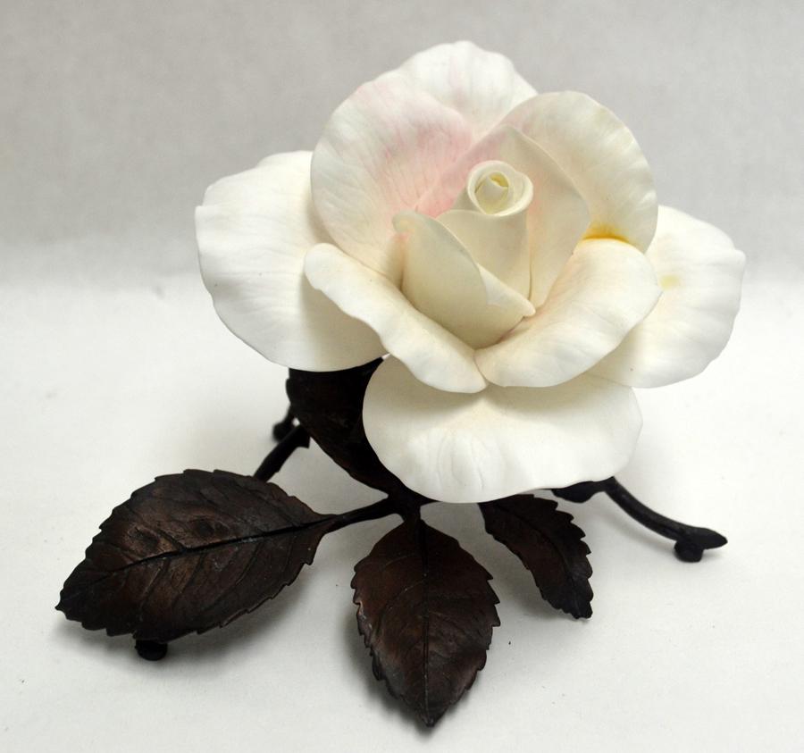 ENGLISH BOEHM, BISQUE PORCELAIN, PEACE ROSE: ENGLISH BOEHM, BISQUE PORCELAIN, PEACE ROSE, H 3 1/2", W 5"An English Boehm bisque porcelain 'Peace Rose' sculpture. A white rose with bronze leaves and stem. Hand-painted bronze and porcelain collect