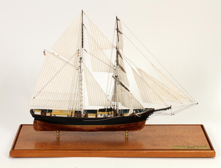 "NEWSBOY OF BOSTON" HAND CARVED MODEL SAILING SHIP: "NEWSBOY OF BOSTON" HAND CARVED, 1/8" = 1', SCALE MODEL SAILING SHIP, C1990, H 15", W 7", L 21" Depicting the 2-masted brigantine ship 'Newsboy Of Boston. The scale is 1/4" = 1'. Mounted on brass stan