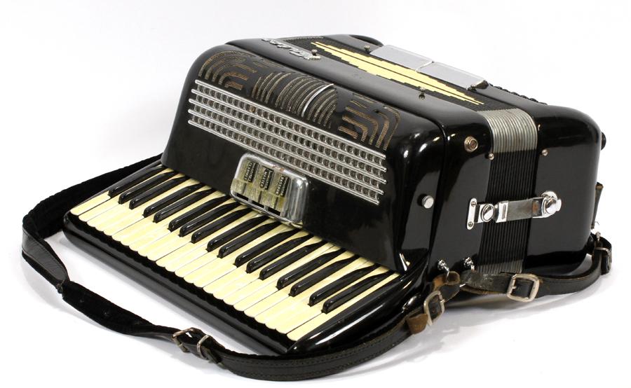 ACCORDION, "VENICE": ACCORDION, "VENICE" Having a black body, three-button settings marked Bassoon, mother-of-pearl keys, Master, and Claranet. Includes a strap and case.