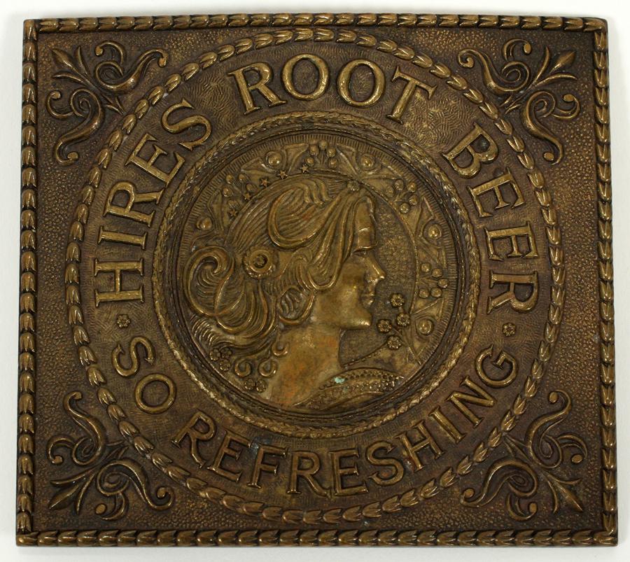 BRONZE BELT BUCKLE, C. 1900, W 3.5", L 3": BRONZE BELT BUCKLE, C. 1900, W 3.5", L 3"A Tiffany & Co. bronze belt buckle. Designed by A.J. Nash for Charles Hire Sr., a Post-Civil War pharmacist who sold his own root beer. Signature branding impr