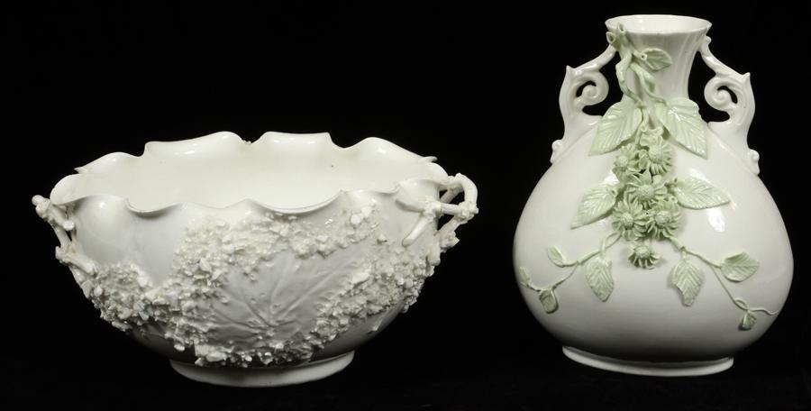 TAYLOR & KNOWLES LOTUS WARE PORCELAIN VASE: KNOWLES, TAYLOR & KNOWLES LOTUS WARE PORCELAIN VASE H 11", 8.5" W 8" A white glazed porcelain vase with pale green applied flowers and two scrolling handles. This item was manufactured by Knowles, Tay