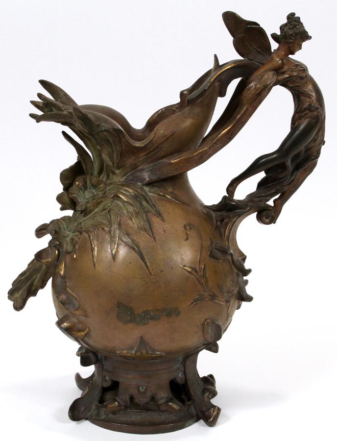 ANTON 'X.P. OR X.R.' NELSON, ACTIVE 1880 - 1910: ANTON 'X.P. OR X.R.' NELSON, ACTIVE 1880 - 1910, SIGNED, ART NOUVEAU BRONZE PITCHER, C. 1890, H 13", W 10"Art Nouveau, Fairy form handle with botanical details in relief. Signed.