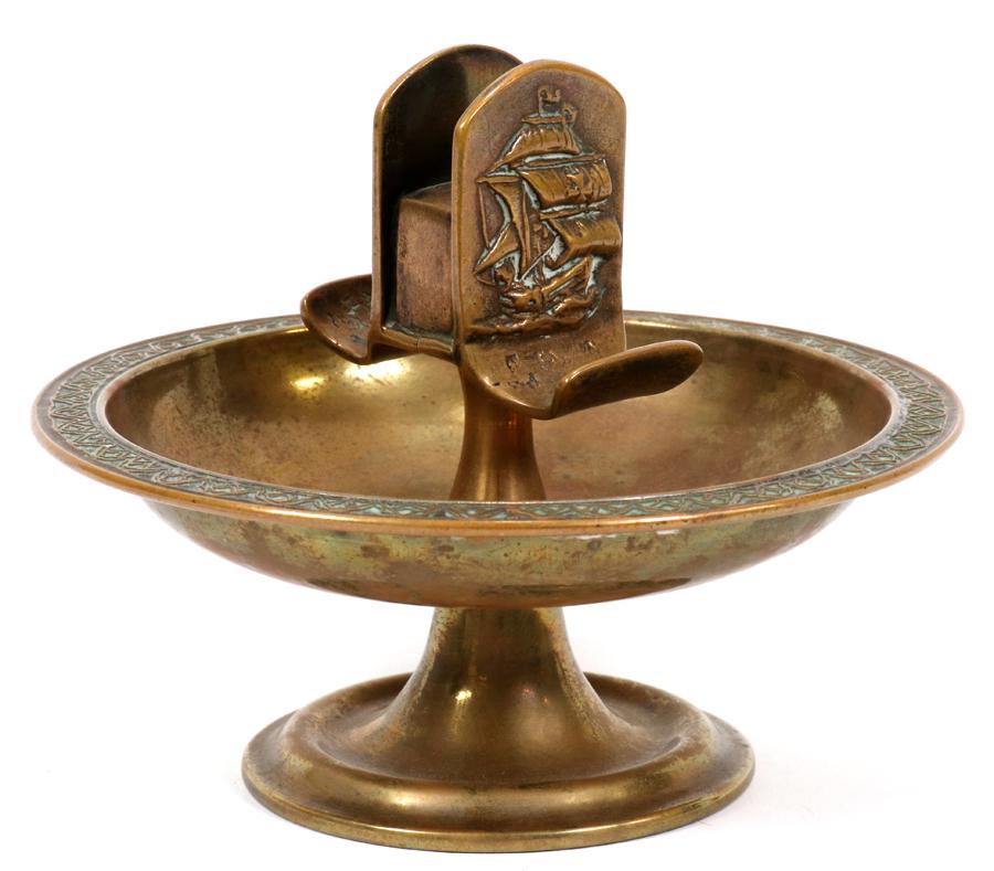 TIFFANY FURNACES, DORE BRONZE ASH RECEIVER, #302: TIFFANY FURNACES, DORE BRONZE ASH RECEIVER, #302, H 5", DIA 6"A Louis C. Tiffany Furnaces, Inc. gilt bronze ash receiver. Having a clipper ship motif and a band of wave forms along the perimeter. Sign