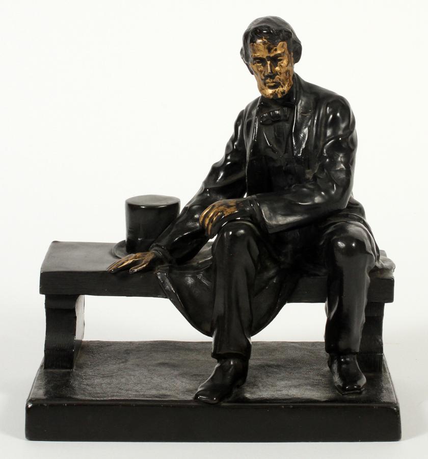 CAST METAL, LINCOLN STATUE, C. 1900: CAST METAL, LINCOLN STATUE, C. 1900 H 7", W 3.5" L 6" Lincoln sitting on a bench.