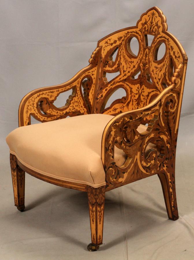BIEDERMEIER INFLUENCED MARQUETRY INLAID CHAIR: BIEDERMEIER INFLUENCED MARQUETRY INLAID CHAIR, H 37.5", W 24", D 21"Pierced scrolling inlaid back and arms. On front casters. Reupholstered with a tan upholstered seat. Property of the Arthur Schwartz