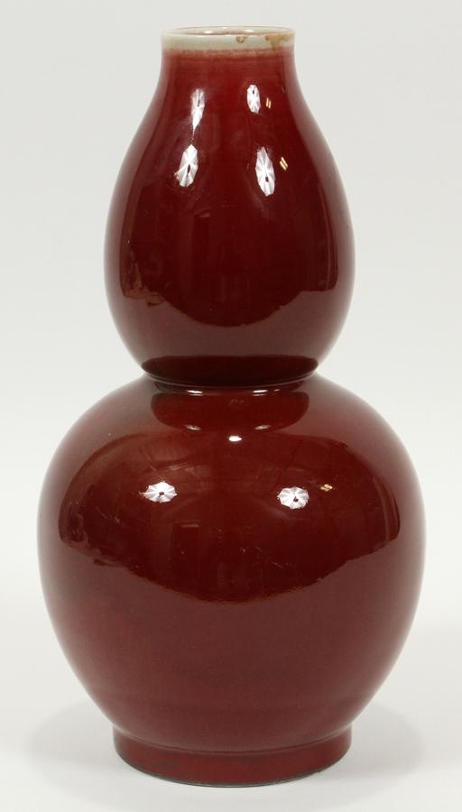 CHINESE PORCELAIN SANG DE BOEUF DOUBLE-GOURD VASE: CHINESE PORCELAIN SANG DE BOEUF DOUBLE-GOURD VASE, 20TH C., H 12", W 6" Impressed K'ang Hsi bottom mark. Provenance: Skinner's, lot 715, April 29, 2006 (bill of sale is in customer file).
