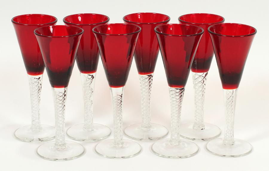 RUBY GLASS WINE GLASSES, 8 PCS, H 7": RUBY GLASS WINE GLASSES, 8 PCS, H 7"A collection of eight ruby glass wine glasses. Each having a ruby red glass basin and a clear stem with elegant twisted air bubbles. Diameter 2.75".