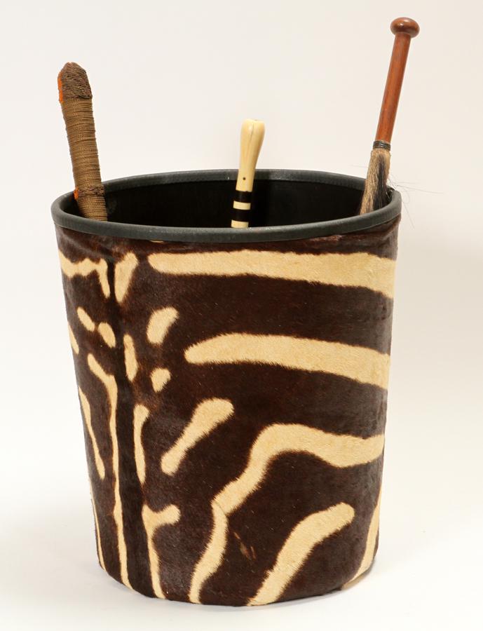 ZEBRA SKIN COVERED CYLINDER & 2 WHISKS: ZEBRA SKIN COVERED CYLINDER & 2 WHISKS Waste basket H 14" x Dia 12". Whisks (1 metal braid handle, 1 bronze and horn handle), L 24".