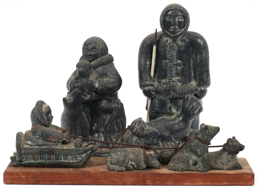 "WOLF" SCULPTURES, INUIT FIGURES, LOT OF 3: "WOLF" SCULPTURES, INUIT FIGURES, LOT OF 3 H 10", 8", 4" Canadian Eskimo figures by Wolf in style of carved soapstone. A) Mother and child 8" B) Eskimo in sleigh pulled by five dogs, on wood base. H 4