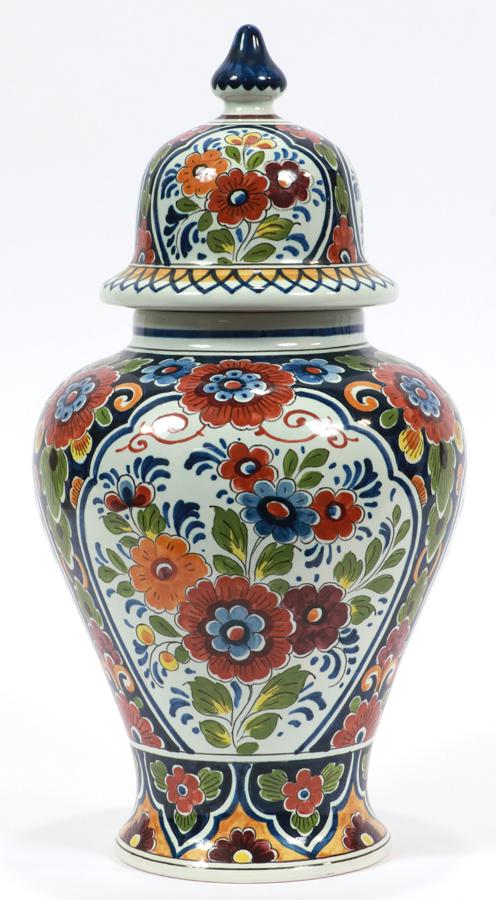 OUD DELFT, DUTCH POTTERY COVERED JAR, H 15" W 8": OUD DELFT, DUTCH POTTERY COVERED JAR, H 15" W 8" Polychromed floral pattern, having three floral panels with white ground separated by floral decoration on a navy ground. Marked "650 OUD Delft S.E.L."