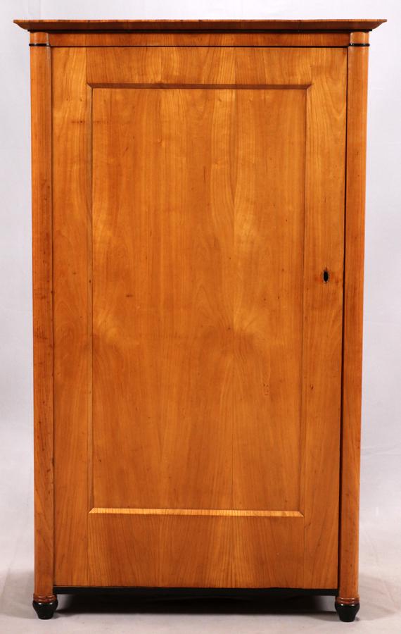 BIEDERMEIER CHERRY CABINET, C. 1850: BIEDERMEIER CHERRY CABINET, C. 1850 H 62", W 36" D 18" A 19th century. The cabinet door opens to reveal four compartments of varying sizes. Paper labels attached to the backside. Having ebonized trim 