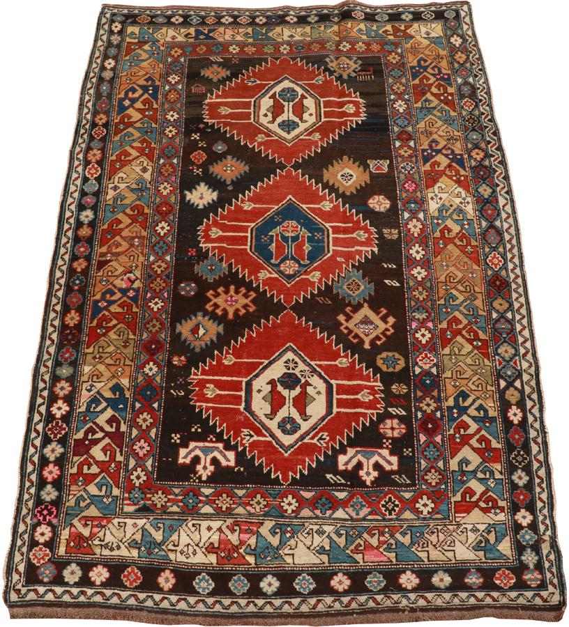 RUSSIAN ANTIQUE CARPET C. 1900 W 3'7" L 5'4": RUSSIAN ANTIQUE CARPET C. 1900 W 3'7" L 5'4" Hand woven, wool. Three central diamond forms.