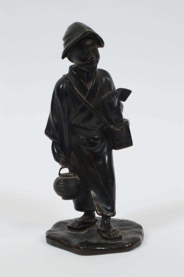 JAPANESE MEIJI PERIOD BRONZE SCULPTURE: JAPANESE MEIJI PERIOD BRONZE SCULPTURE 19TH C. H 7" Signed. Standing happy young man carrying book and lantern. Dark brown patina.