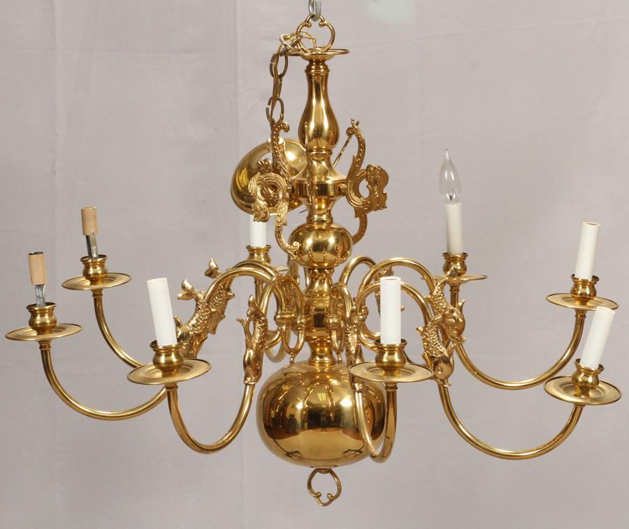 EIGHT LIGHT, BRASS CHANDELIER, H 24", DIA 32": EIGHT LIGHT, BRASS CHANDELIER, H 24", DIA 32" Brass chandelier with 8 arms. Each arm having a small figural dolphin, approx. 3" in length, attached at mid-arm. The chandelier is contemporary.