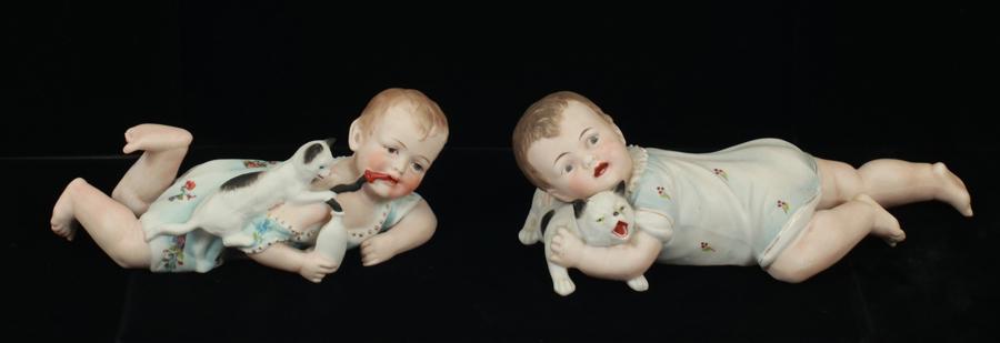 BISQUE HAND PAINTED PIANO BABIES WITH CATS, TWO: BISQUE HAND PAINTED PIANO BABIES WITH CATS, TWO L 8", 10" Early 20th.c.