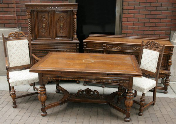 TUDOR OAK DINING ROOM SET, CIRCA 1920, NINE: TUDOR OAK DINING ROOM SET, CIRCA 1920, NINE PIECES:Set includes a refractory table H 30 1/2", L 60", D 38" with the end leaves L 18 1/2", one arm chair and five side chairs H 42 1/2", a server with fo
