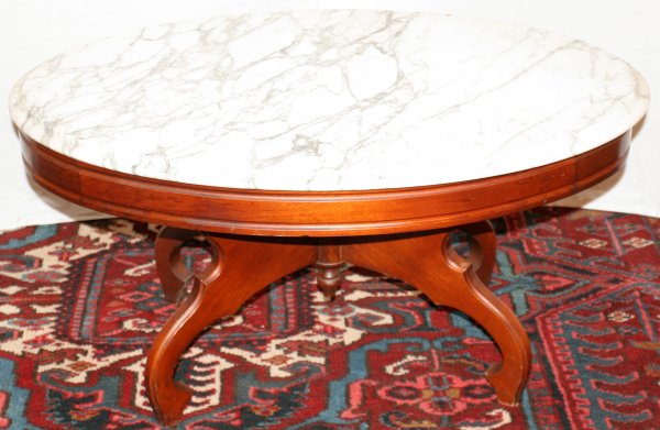 VICTORIAN STYLE COFFEE TABLE WITH MARBLE TOP: VICTORIAN STYLE COFFEE TABLE WITH MARBLE TOP, C. 1940, H 17", W 22", L 34":White beveled marble top. Mahogany base. Grand Rapids, circa 1940. H 17", L 34", D 22".