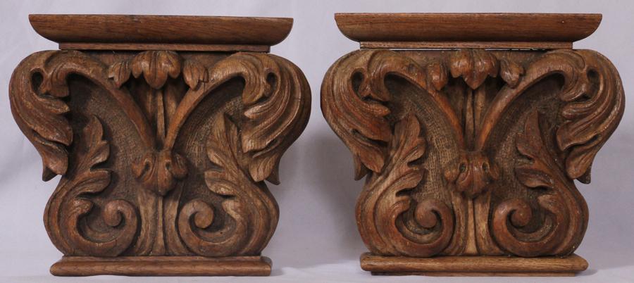 CARVED OAK CORINTHIAN CAPITOLS, PAIR: CARVED OAK CORINTHIAN CAPITOLS, PAIR, H 13", W 14"A pair of carved oak Corinthian capitols. Each having scroll form and acanthus leaf motifs. Each hang by D-hook. Previously purchased at Doyle's (NY).